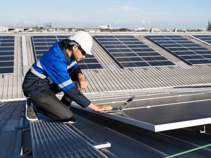 worker installing solar panels