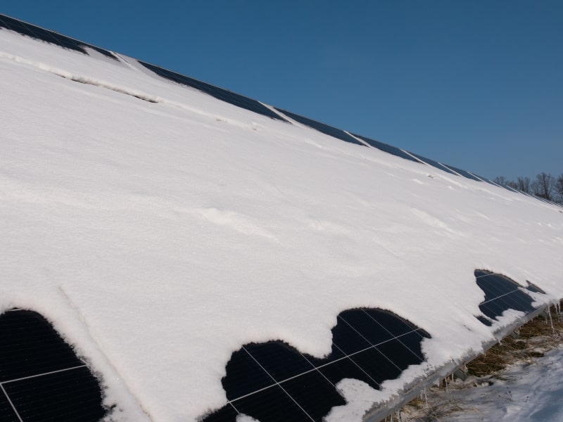 black solar panel with snow