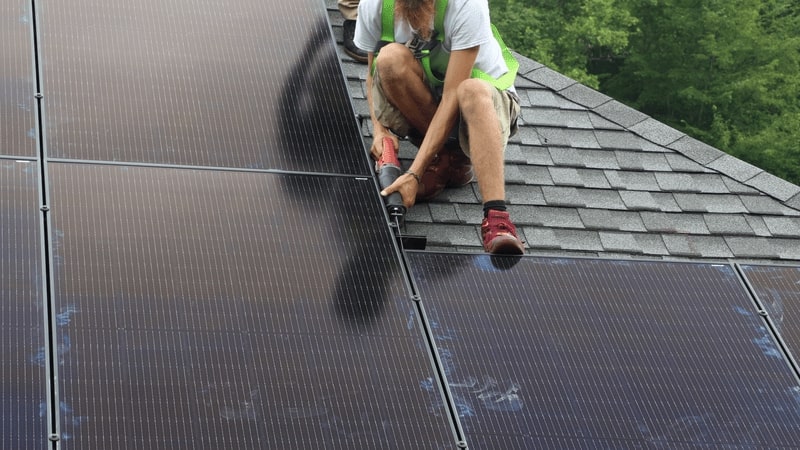 man working on solar panel